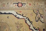 Vintage Armenian Serapi rug with geometric border and oblong medallion in beige, black, and terra cotta.