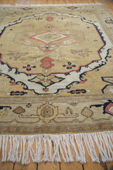 Armenian Serapi carpet's cream fringe and bold border, featuring beige, black, terra cotta geometric patterns.