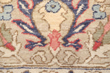 Large-scale palmette motif detailed in navy, red, and powder blue on a beige wool pile.