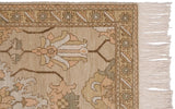 Rhythmic geometric floral border and soft ivory fringe of the Armenian Sultanabad rug.