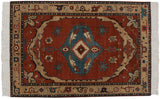 Vintage Armenian Serapi carpet with a bold blue center medallion on a brick red field and a wide, sand-colored border.