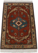 Angled view of a hand-knotted Armenian carpet with a bold Serapi design in red, blue, and beige.