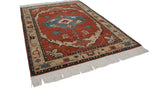 Side view of the hand-knotted Armenian Serapi carpet's plush pile, geometric border, and fringe.