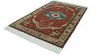 The entire vintage Armenian Serapi carpet at an angle, highlighting its bold medallion, borders, and fringe.