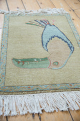 White fringe and powder blue meandering vine border with blush buds on Armenian rug.
