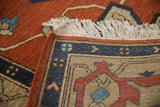 Ivory fringe, red selvage, and geometric blue border of a vintage Armenian Serapi rug.