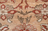 Plush texture of the hand-knotted wool pile showing checkered lily palmettes in rust and sand.