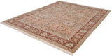 Angled view of the entire vintage Armenian carpet, with a rust border and sand-colored floral field.