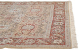 Corner view of a vintage Armenian carpet showing the plush pile, rust floral border, and clean fringe.