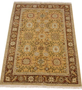 Vintage Armenian Sultanabad rug from an angle, showing its dense pile and golden saffron field.