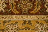 Detail of Armenian script woven into a beige border on a hand-knotted Sultanabad rug.