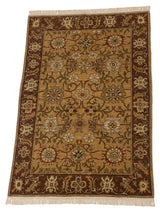 Full length view of the Armenian Sultanabad rug's floral palmettes on a saffron gold field.