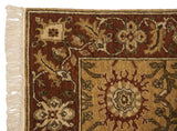 Corner of the vintage Armenian rug showing its plush pile, scrolling vinery border, and neat ivory fringe.