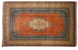 Corner of a vintage Bulgarian carpet showing plush pile, Rococo vinery, and intact side cord selvage.