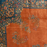 European-influenced scrolling vinery in the sky blue border meeting the pale terra cotta field.