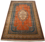 Angled perspective of a large Bulgarian Kerman design carpet, showcasing its terracotta field and ornate floral borders.