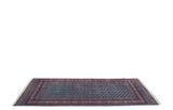 Angled view of a fine Bokhara carpet highlighting its repeating gul medallions and lustrous wool pile.