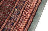 Intact side cord selvage and dense wool pile of a vintage red and blue Bokhara carpet.