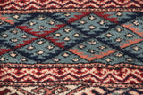Plush wool pile showing geometric Bokhara guls in powder blue, navy, and madder red.