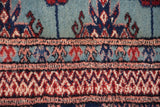 Plush wool pile showing the fine weave of a Bokhara carpet's geometric border patterns.