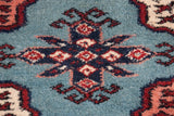 Close-up of the plush wool pile and detailed weave of a Bokhara carpet's geometric gul medallion.