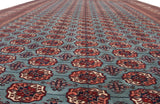Rows of repeating gul medallions extend down the length of this vintage Bokhara carpet.