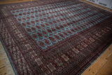 The intricate, multi-layered border and soft ivory fringe on a vintage Pakistani Bokhara carpet corner.