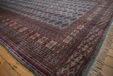Intricate geometric border in red and navy alongside the rug's powder blue side cord selvage.
