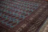 Lustrous wool pile and detailed border of a fine Bokhara carpet shown from a low angle.