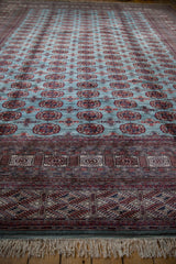 A low-angle view of a fine Bokhara carpet, highlighting its detailed geometric end border.