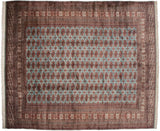 Fine vintage Bokhara carpet with repeating rust and navy gul medallions on a powder blue field.
