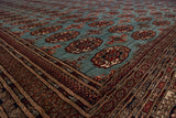 Angled view of the lustrous wool pile and repeating gul medallions of a Bokhara carpet.