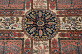 A detailed view of the navy blue pomegranate roundel medallion and terracotta paneled motifs.