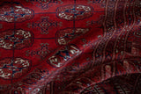 Soft folds highlighting the lustrous, high-sheen wool pile of a vintage Bokhara rug.