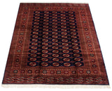 The full length of a vintage Bokhara carpet showing its repeating gul medallions and sheen.
