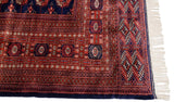Plush wool pile, intact side cord, and clean ivory fringe on the corner of a fine Bokhara carpet.