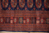 Fine wool pile showing the intricate geometric border of a vintage Pakistani Bokhara rug.