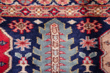 Plush Caucasian design rug detail: navy field, ocean blue leaf, raspberry florals.