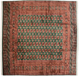 Fine vintage Bokhara square carpet with a grid of rust gul medallions on an emerald green ground.