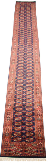 Vintage Bokhara runner featuring detailed geometric gul medallions in navy blue and rust.