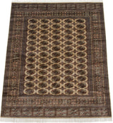 The lustrous wool pile and geometric gul pattern of a vintage Bokhara carpet.