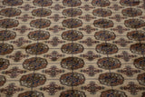 High-sheen wool pile showing detailed geometric gul medallions in navy, bronze, and terracotta.