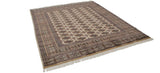 Angled view of a lustrous vintage Bokhara carpet with repeating gul medallions and detailed borders.