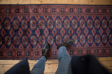 Close-up of the plush wool pile and repeating gul motifs of a fine Bokhara runner.