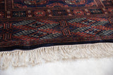 The lustrous, plush pile and clean ivory fringe of a vintage fine Bokhara rug runner.