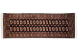 Fine vintage Bokhara runner, black field with terra cotta and ivory gul medallions, 2'7