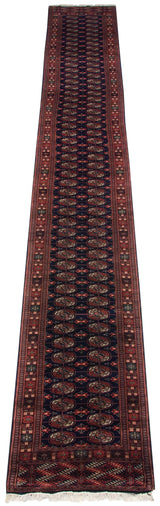 Dynamic sheen on the full length of a vintage Bokhara rug runner with traditional gul medallions.