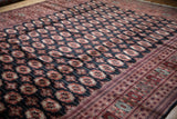 Angled view highlighting the plush, silk-like pile and repeating gul medallions of a Bokhara carpet.