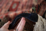 Plush, full-height wool pile and intact black side cord of a vintage Bokhara carpet.