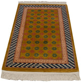 Corner of vintage Chinese Art Deco rug with blush running-T and blue stacked cube borders.